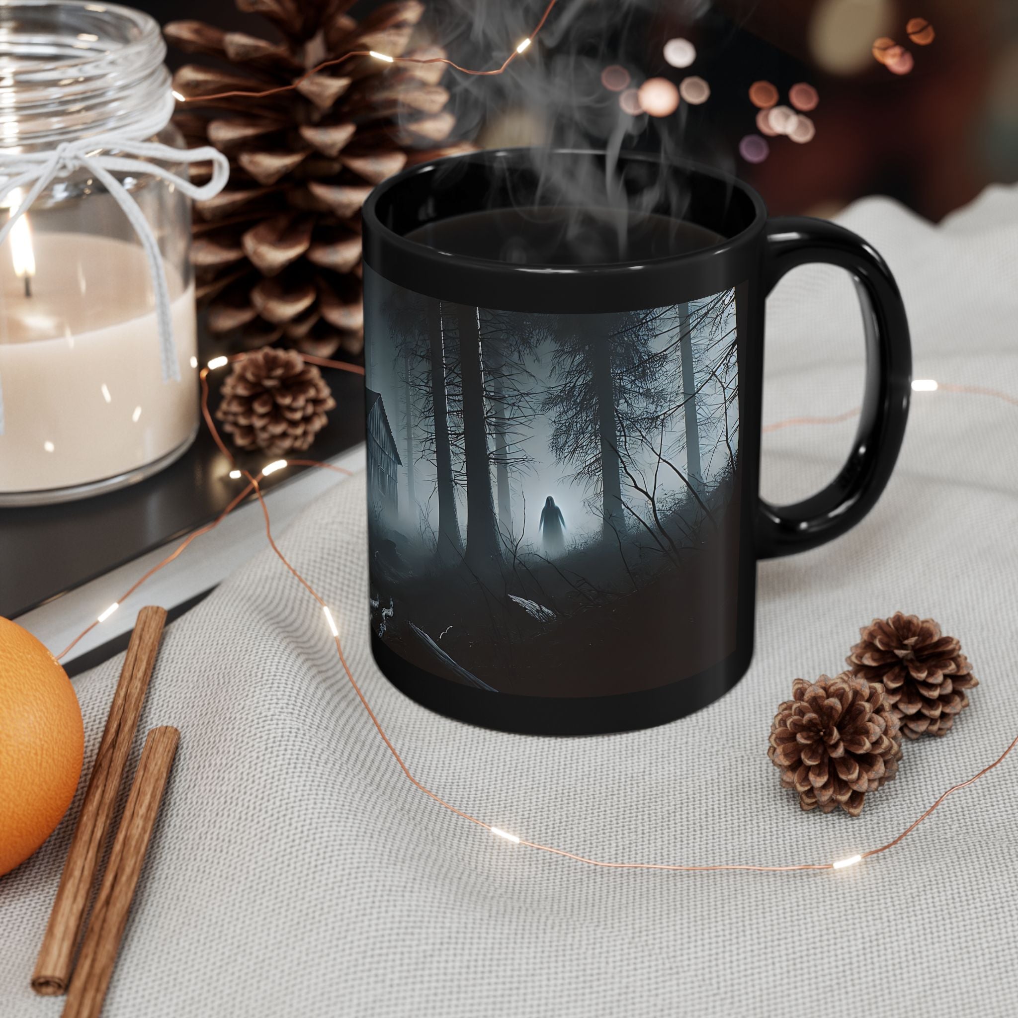 Black ceramic Deep Woods Cabin mug with misty forest scene, eerie cabin, and shadowy figure artwork.