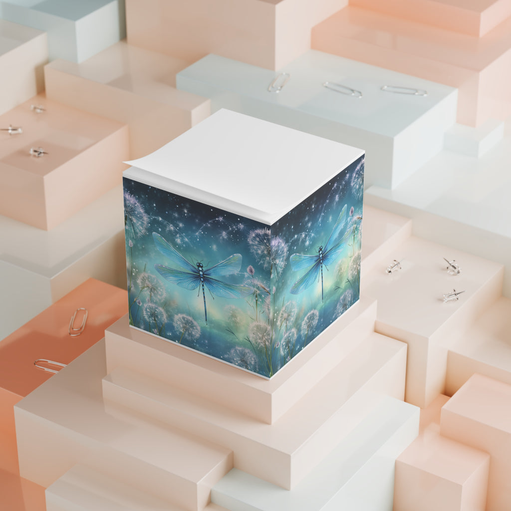 Decorative cube with dragonfly and dandelion design on a geometric background