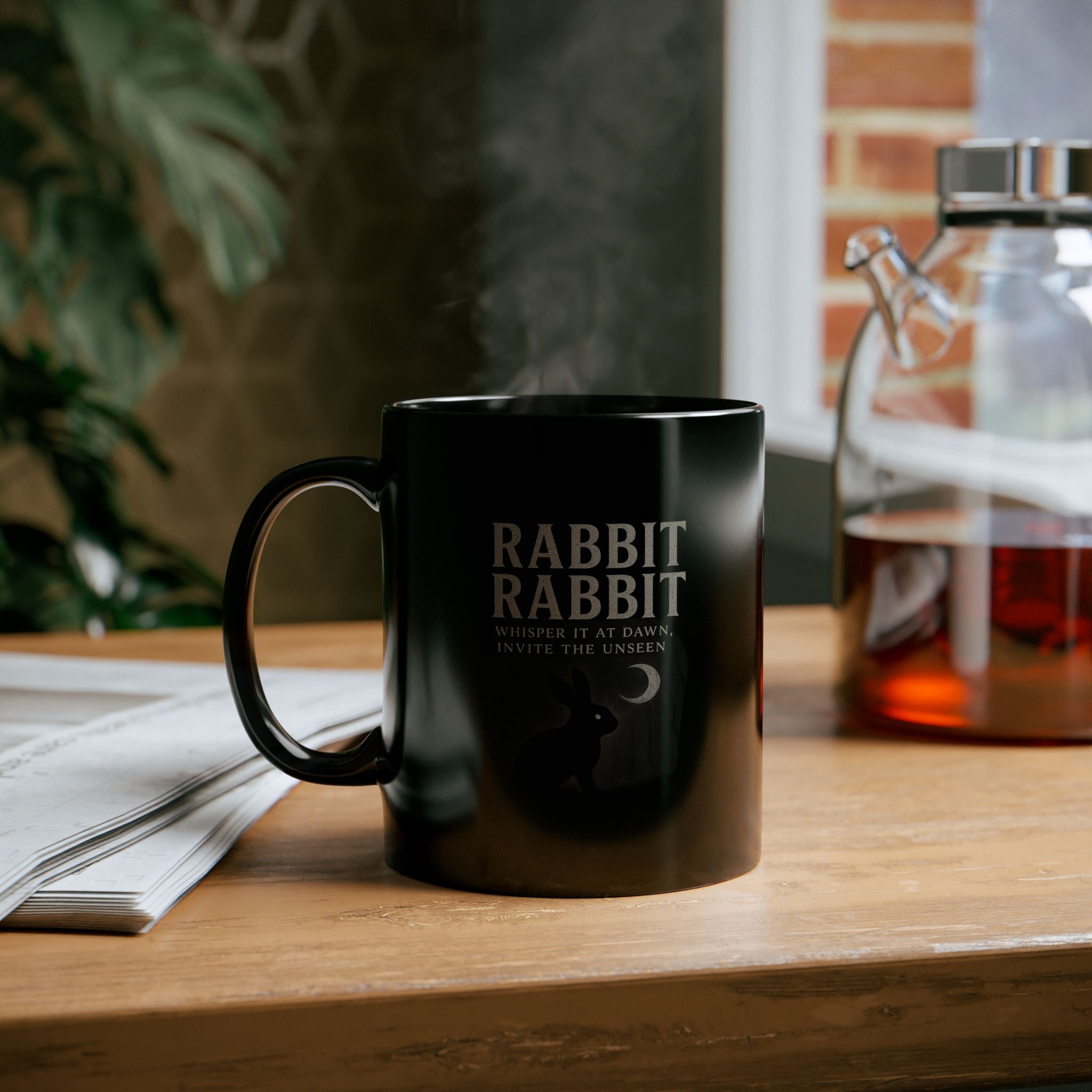 Front view of Rabbit Rabbit Black Mug highlighting spooky gothic artwork and handle