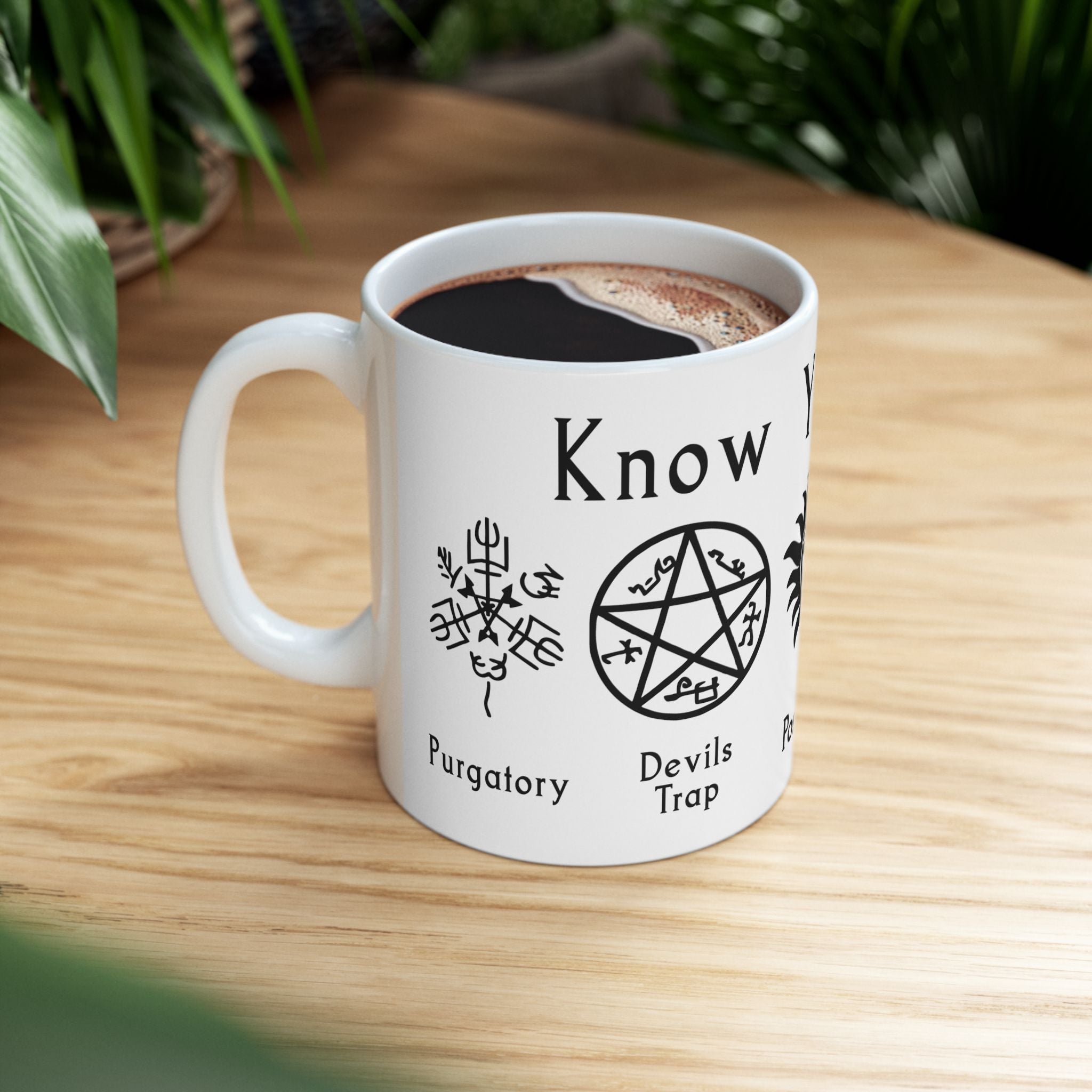 Side view of witchcraft-themed mug filled with coffee